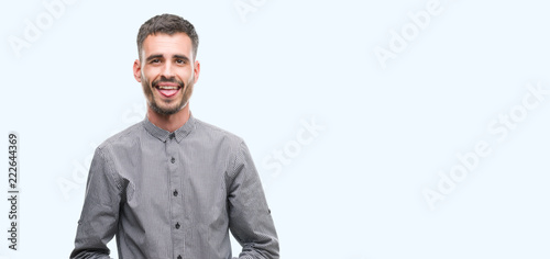 Young hipster man sticking tongue out happy with funny expression. Emotion concept. © Krakenimages.com