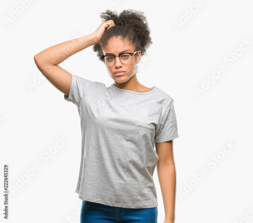 Young afro american woman wearing glasses over isolated background confuse and wonder about question. Uncertain with doubt, thinking with hand on head. Pensive concept.