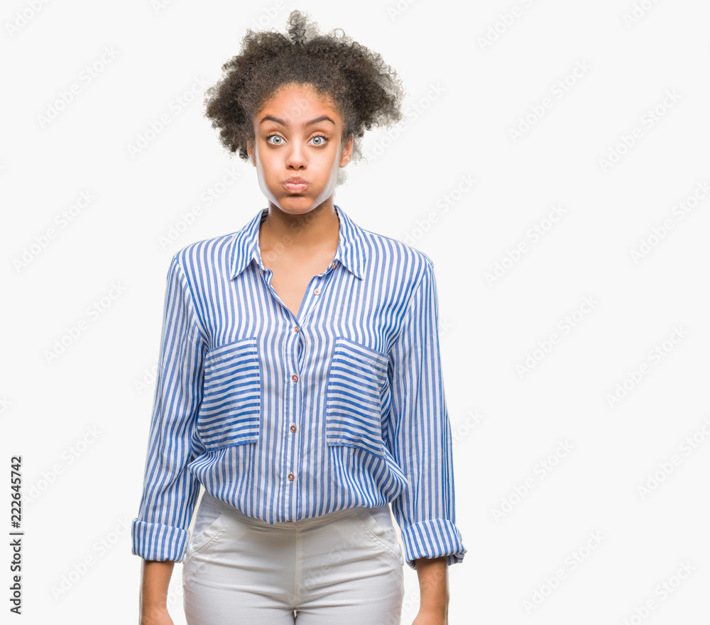 Young afro american woman over isolated background puffing cheeks with funny face. Mouth inflated with air, crazy expression. Young afro american woman over isolated background puffing cheeks with funny face. Mouth inflated with air, crazy expression.