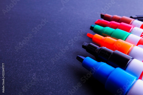 Colorful markers pens Multicolored on black background.