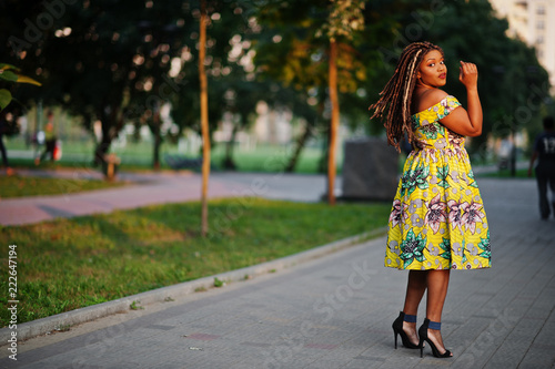 Cute small height african american girl with dreadlocks, wear at coloured yellow dress, posed at sunset. © AS Photo Family