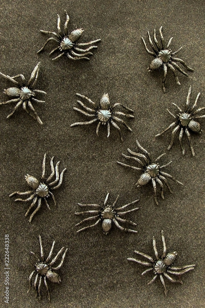 Black rubber spider toys on velvet background. Dark halloween october concept. Black rubber spider toys on velvet background. Dark halloween october concept.