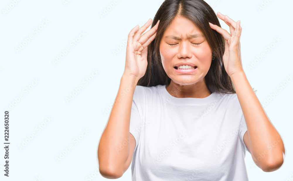 Young asian woman over isolated background with hand on head for pain in head because stress. Suffering migraine. Young asian woman over isolated background with hand on head for pain in head because stress. Suffering migraine.
