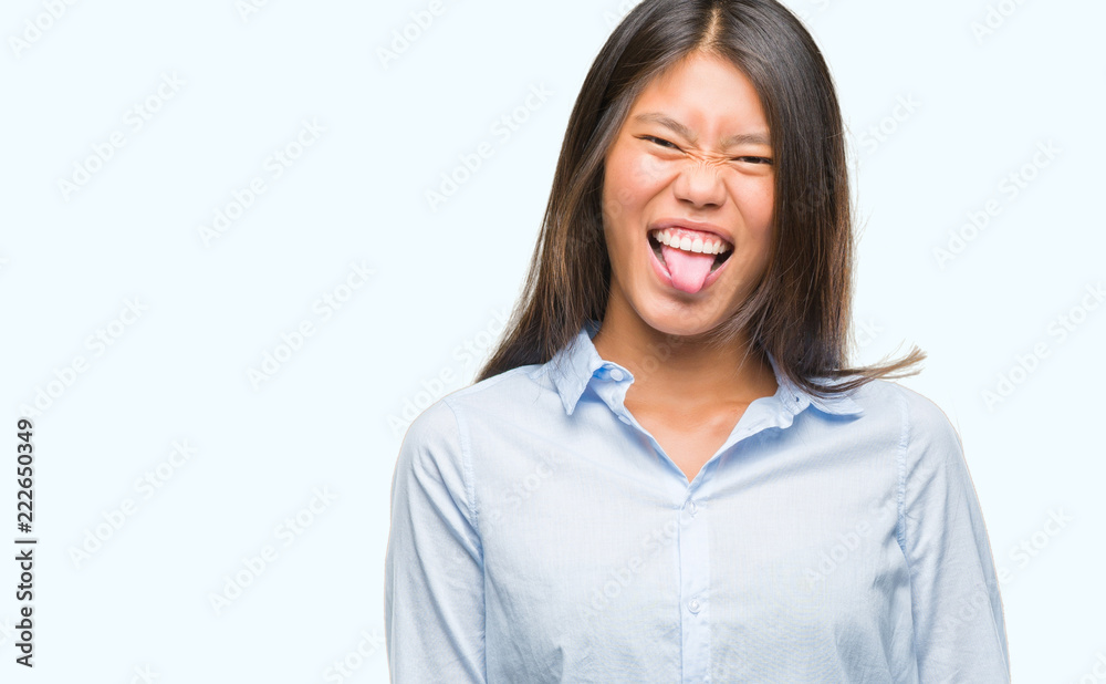 Young asian business woman over isolated background sticking tongue out happy with funny expression. Emotion concept. Young asian business woman over isolated background sticking tongue out happy with funny expression. Emotion concept.