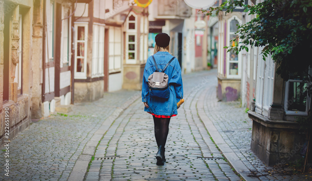 Young lady in jeans jacket on medieval street of Bremen, Germany. Trevel destination concept