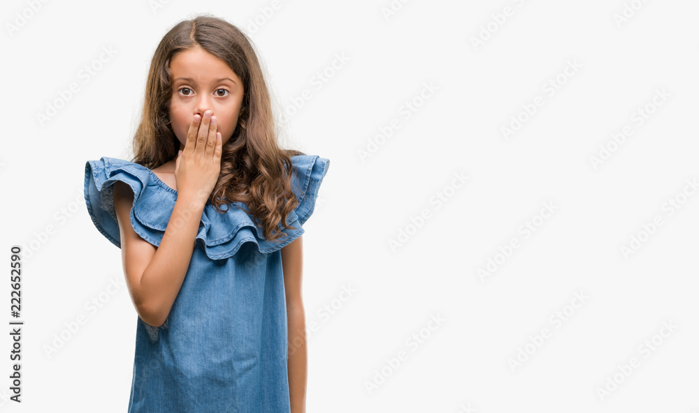 Brunette hispanic girl wearing denim dress cover mouth with hand shocked with shame for mistake, expression of fear, scared in silence, secret concept Brunette hispanic girl wearing denim dress cover mouth with hand shocked with shame for mistake, expression of fear, scared in silence, secret concept