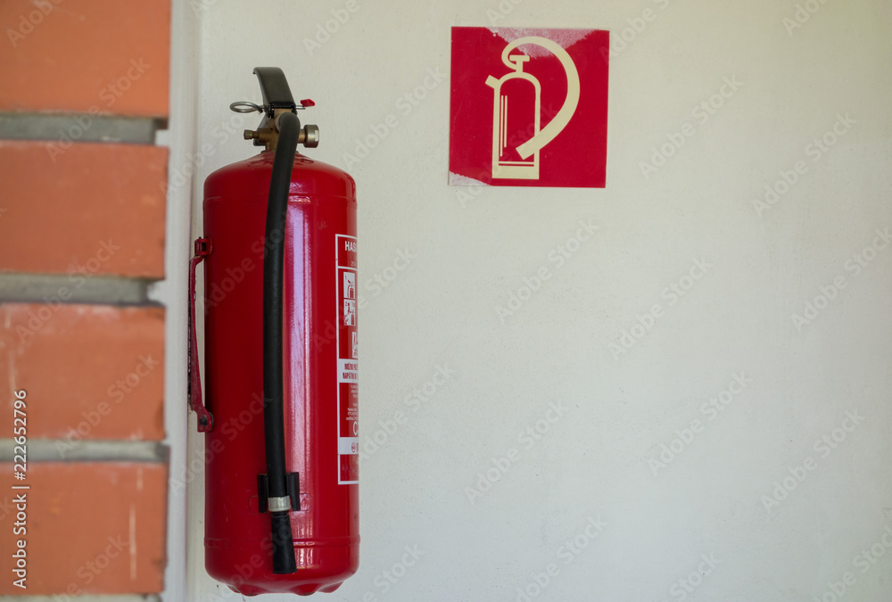 the fire extinguisher is suspended on the wall the fire extinguisher is suspended on the wall