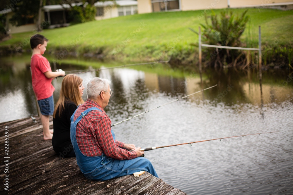Elderly Man Fishing with Granddaughter and Great Grandson Elderly Man Fishing with Granddaughter and Great Grandson