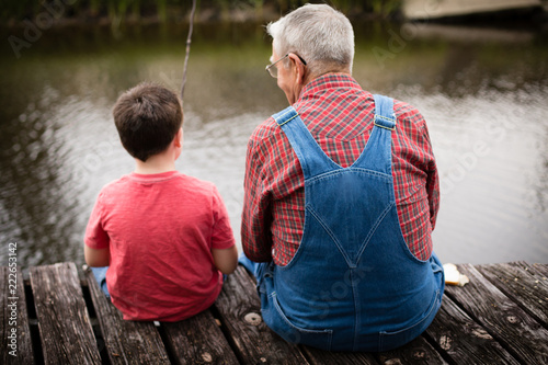 Happy Great Grandfather and Grandson Fishing Together