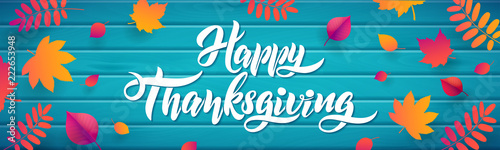 Vector Hand drawn Happy Thanksgiving typography poster with fallen leaves on wood turquoise background