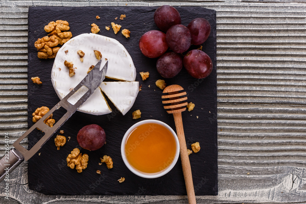 delicious creamy camembert cheese on a wooden rustic background delicious creamy camembert cheese on a wooden rustic background