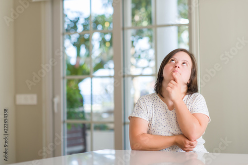 Down syndrome woman at home serious face thinking about question, very confused idea Free Download Down syndrome woman at home serious face thinking about question, very confused idea - GFXLoad
