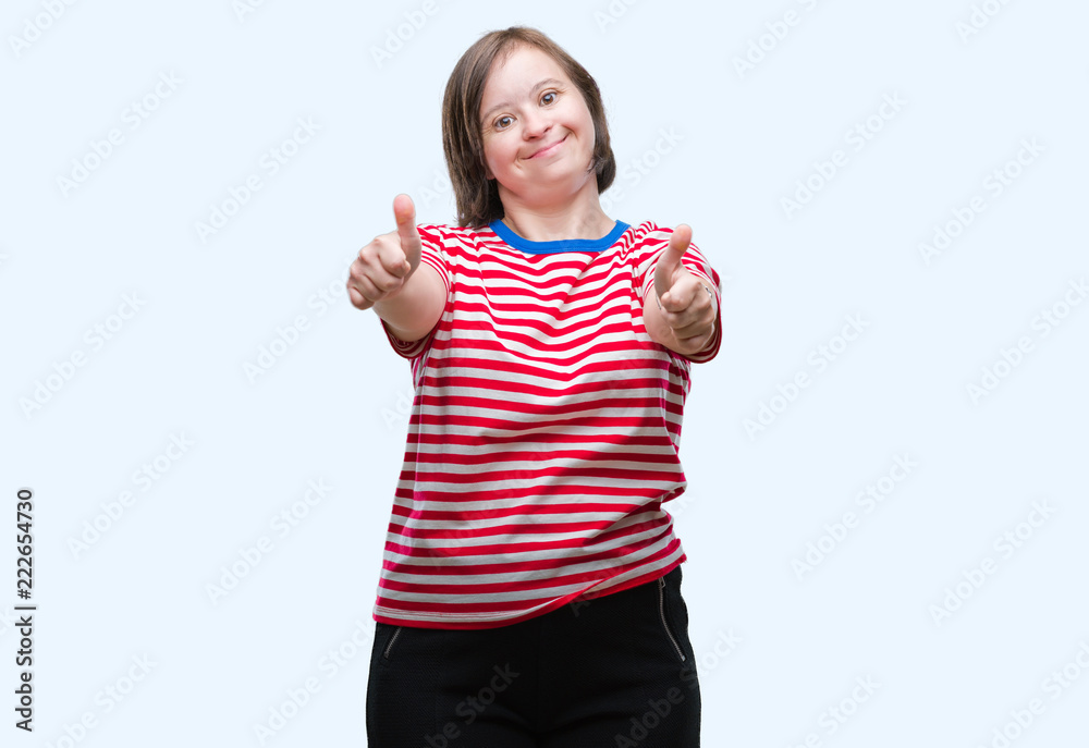 Young adult woman with down syndrome over isolated background approving doing positive gesture with hand, thumbs up smiling and happy for success. Looking at the camera, winner gesture. Young adult woman with down syndrome over isolated background approving doing positive gesture with hand, thumbs up smiling and happy for success. Looking at the camera, winner gesture.