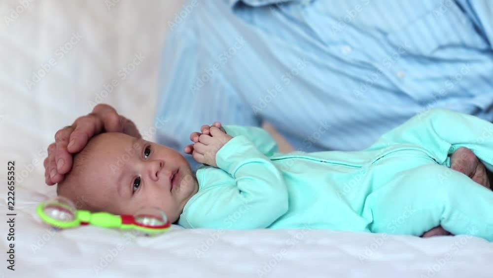 Grandfather plays with little baby boy. Little baby boy and hands of grandfather. Grandad plays with grandson Grandfather plays with little baby boy. Little baby boy and hands of grandfather. Grandad plays with grandson