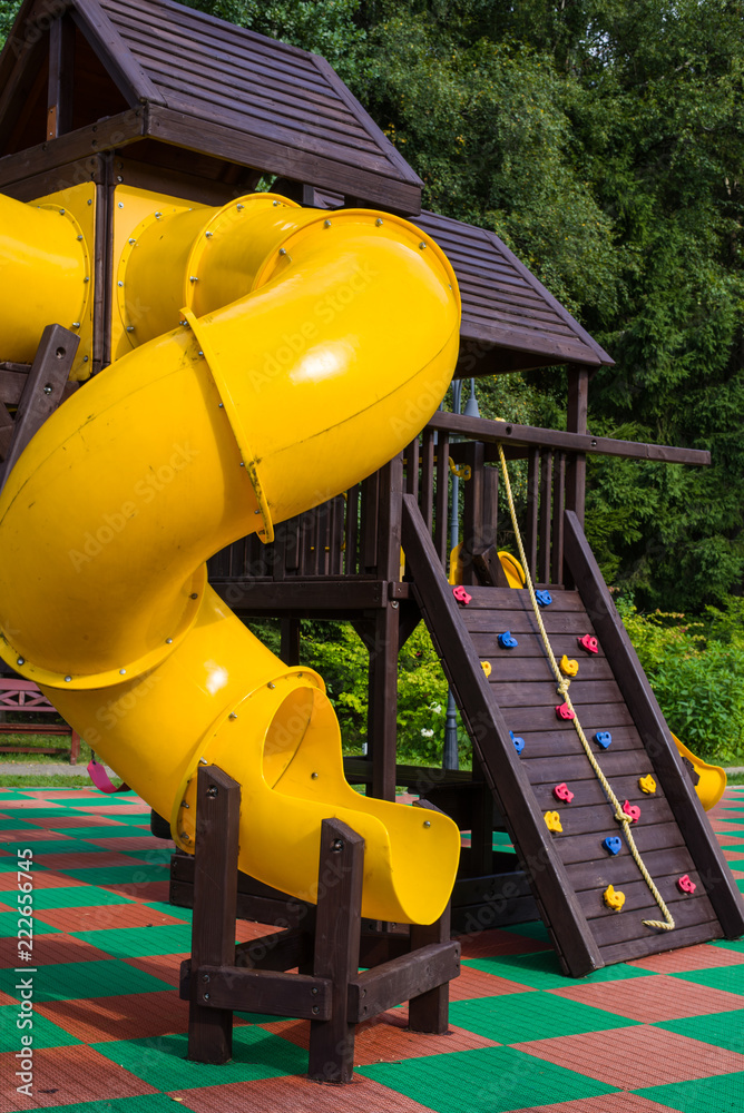 kindergarten, children's playground in the Park, children's yellow slide, slide for children (vertically, close up)