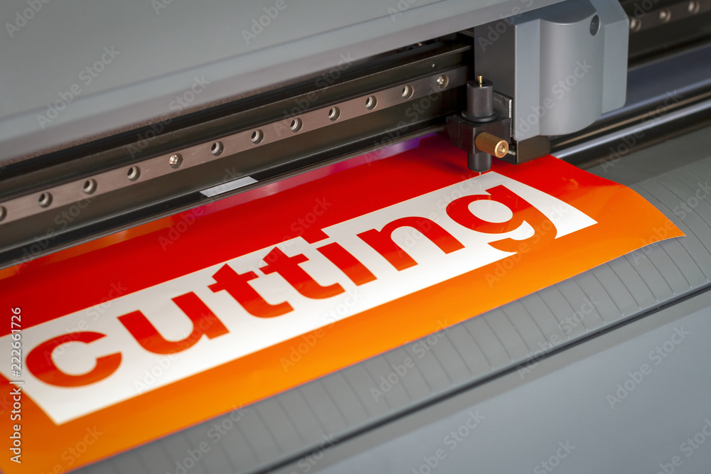 Cutting plotter close-up. The process of cutting a vinyl film. Cutting plotter close-up. The process of cutting a vinyl film.