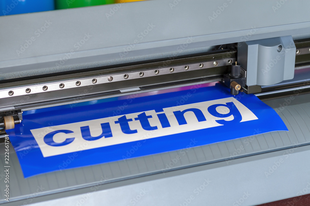 Cutting plotter close-up. The process of cutting a vinyl film. Cutting plotter close-up. The process of cutting a vinyl film.