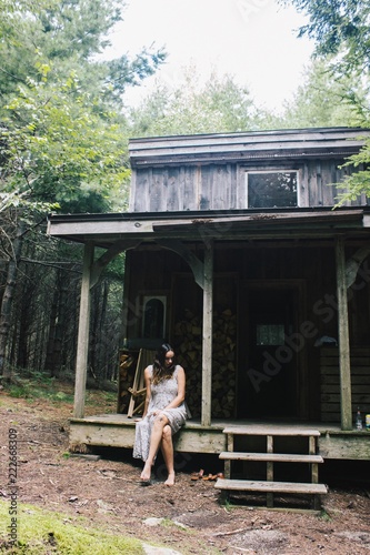 woman in front of a cabin