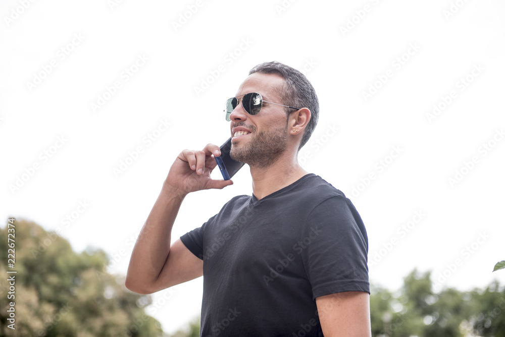 Attractive man talking with his smartphone Attractive man talking with his smartphone