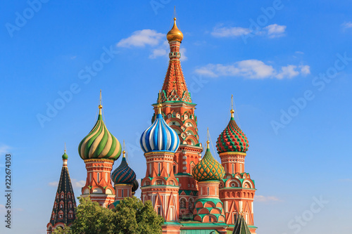 Onion domes of St. Basil's Cathedral in Moscow against blue sky on a sunny summer evening