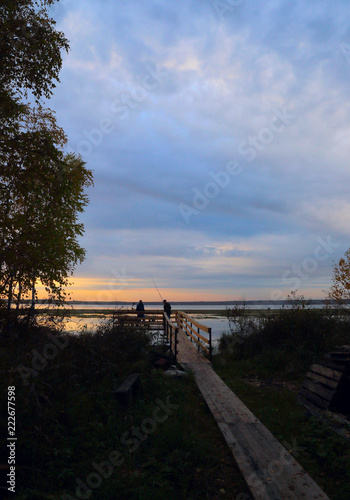 fishermen on the lake at sunset