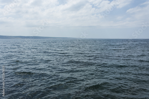 Sea view with waves. Exact horizontal horizon. Blue sea level.