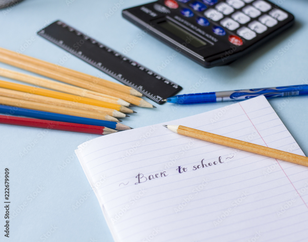 Notepad, pencils, calculator on the table flat lay Notepad, pencils, calculator on the table flat lay