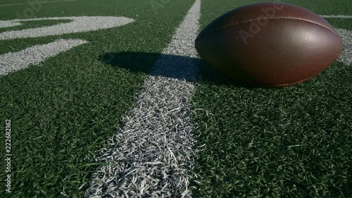 FOOTBALL JUST ON THE 20 YARD LINE.  4K, CLOSE UP SLIDER SHOT.