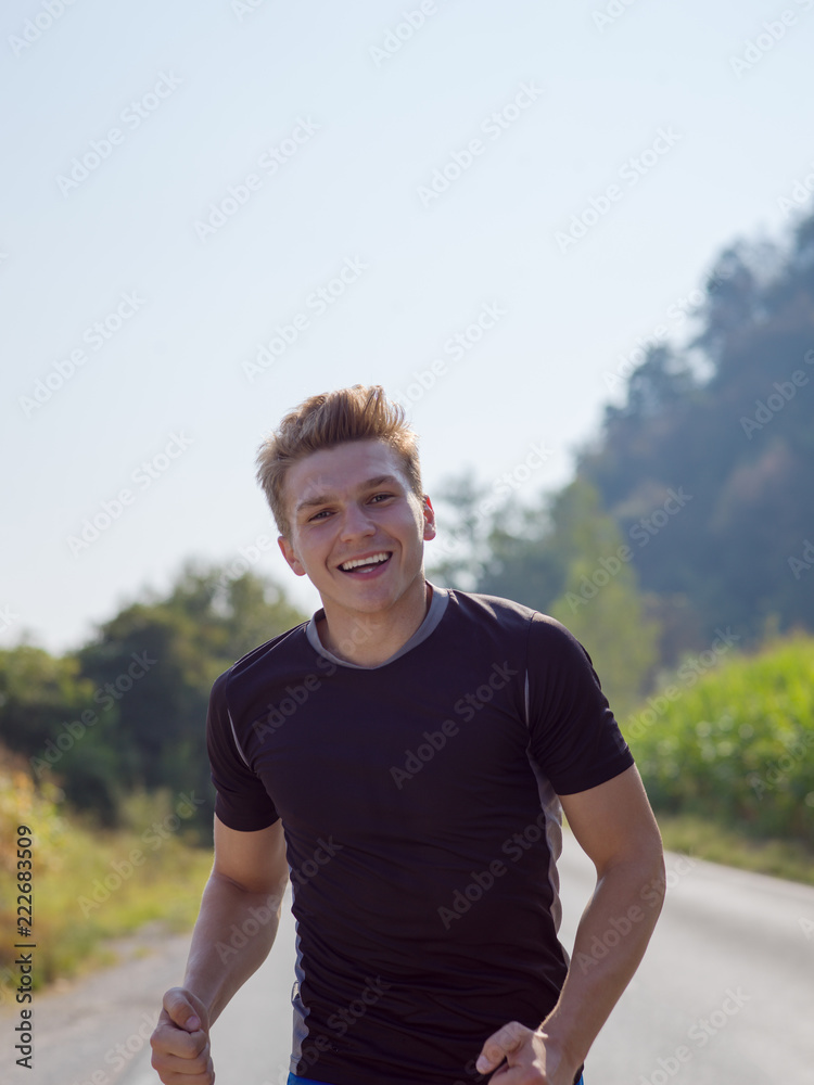 man jogging along a country road