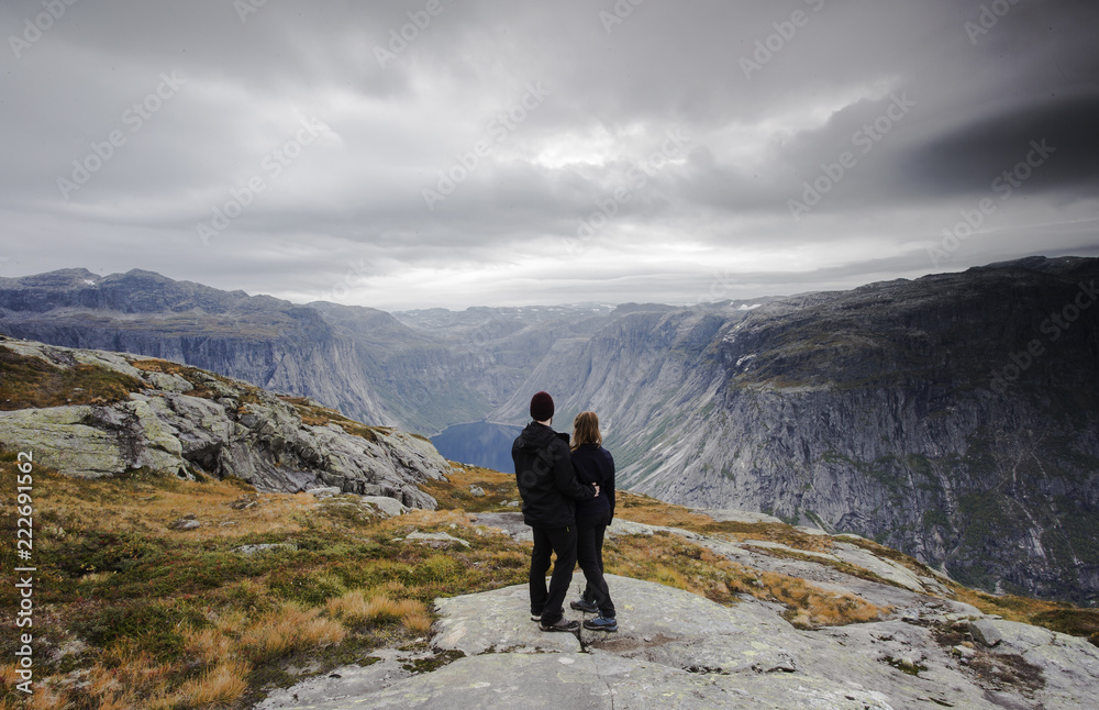 Couple traveling, A couple watching the great view of snow mountains and glaciers in Norway