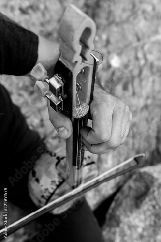 A man playing traditional rebab