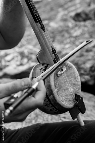 A man playing traditional rebab photo