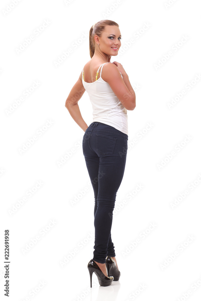 Full length portrait woman in a white tank top and jeans. Full length portrait woman in a white tank top and jeans.