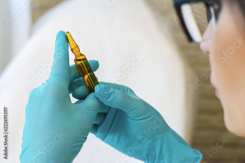 ampoule with medicine in the hands of a doctor