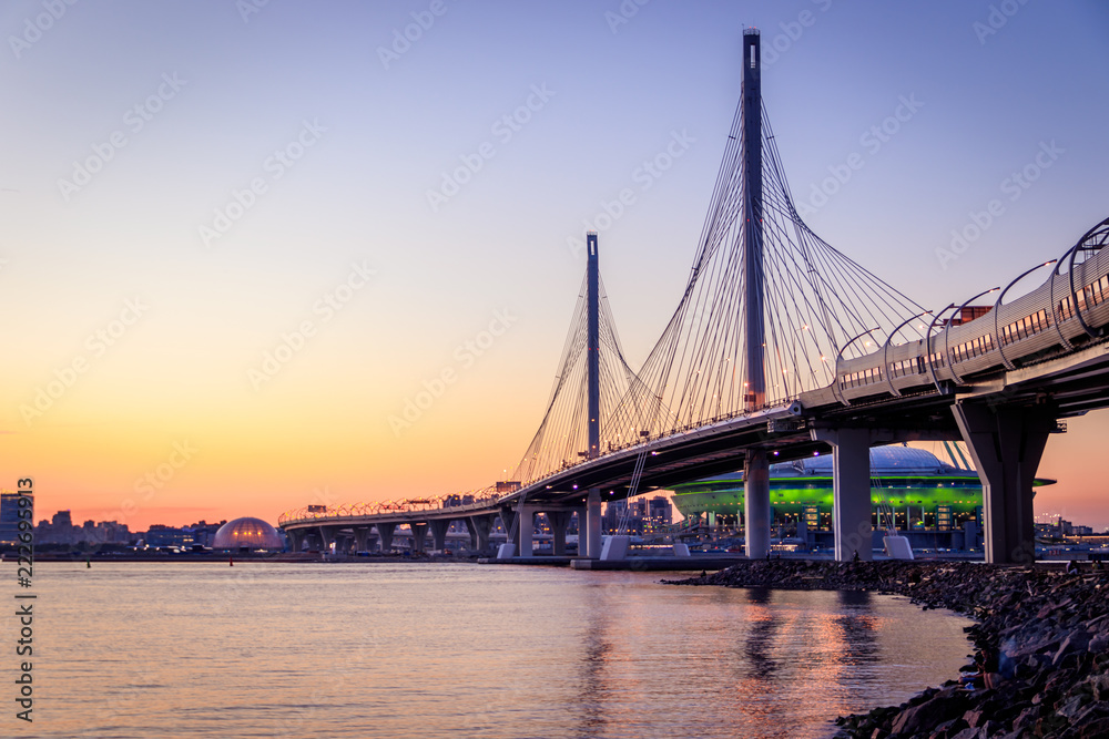 WHSD bridge in St. Petersburg in the evening at sunset. High-speed bypass toll road. Petersburg bridges. New modern bridge. Modern construction technologies. WHSD bridge in St. Petersburg in the evening at sunset. High-speed bypass toll road. Petersburg bridges. New modern bridge. Modern construction technologies.