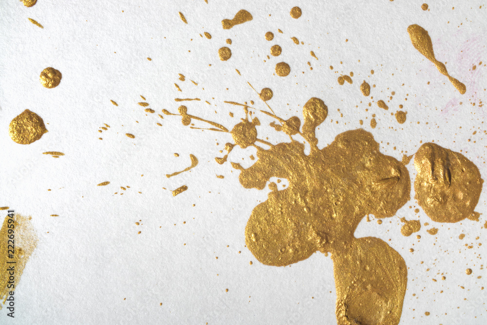 Trendy golden paint drops of gold paint. blot with a splash of metallic  shiny color. Stock Photo