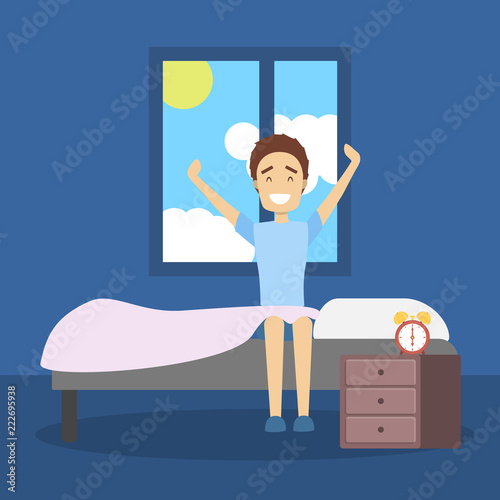 Handsome young man strecthing up in the bed