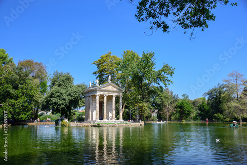 Rome Italy. Garden of Villa Borghese. Lake with boats and temple of Aesculapius,(tempio di Esculapio)