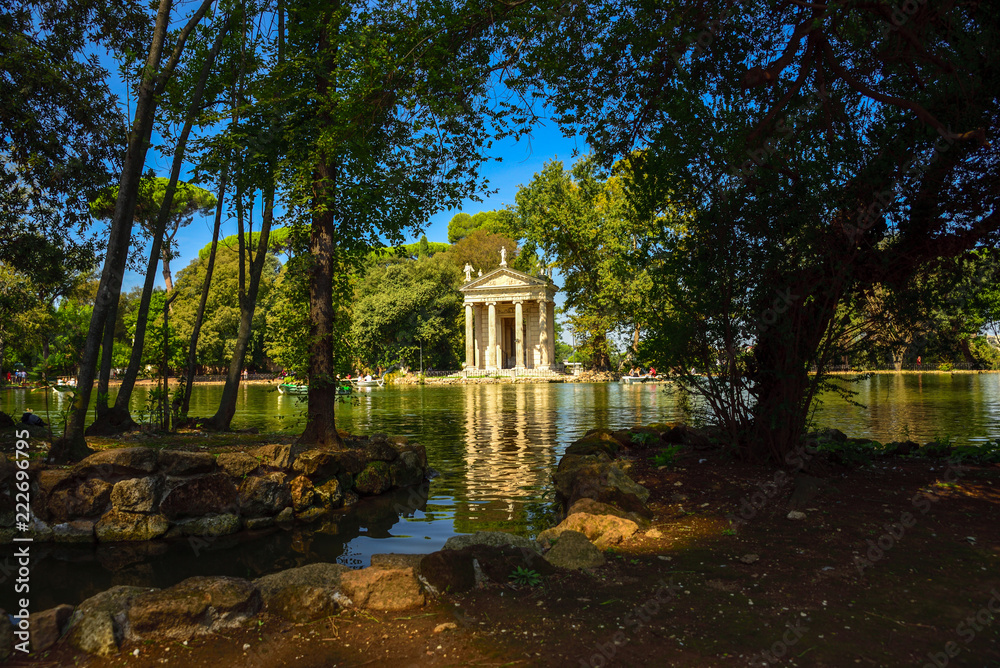 Rome Italy. Garden of Villa Borghese. Lake with boats and temple of Aesculapius (tempio di Esculapio)