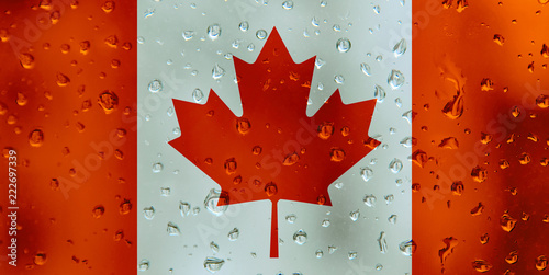Flag of Canada on a water drops background. Canadian Flags waterdrop texture.