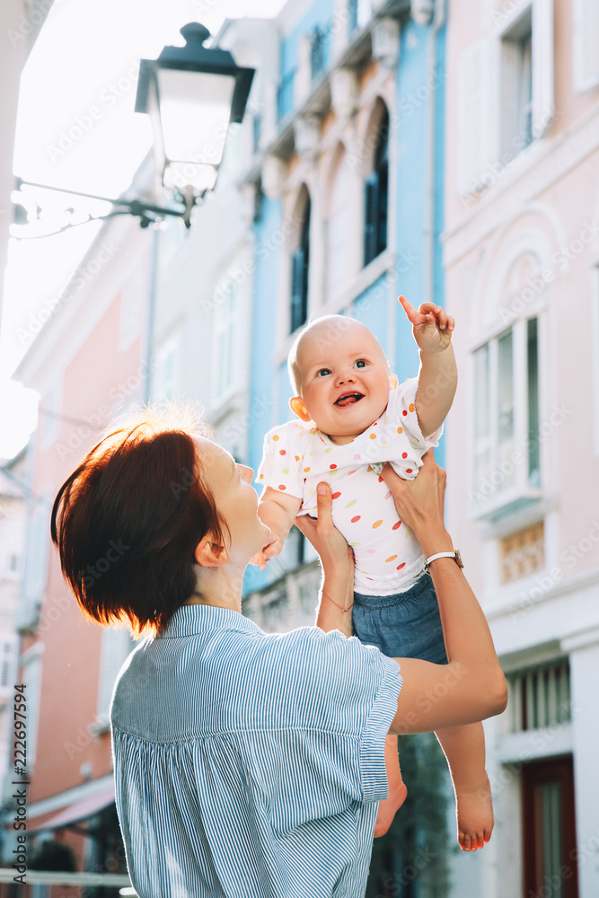 Naklejka premium Mother with baby in historical old town of Piran, Slovenia