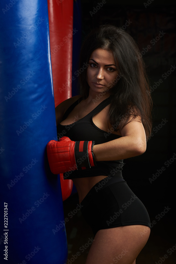 Woman punching boxing bag