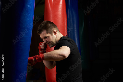 Caucasian man punching boxing bag