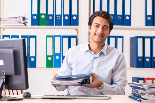 Young male employee working in the office photo