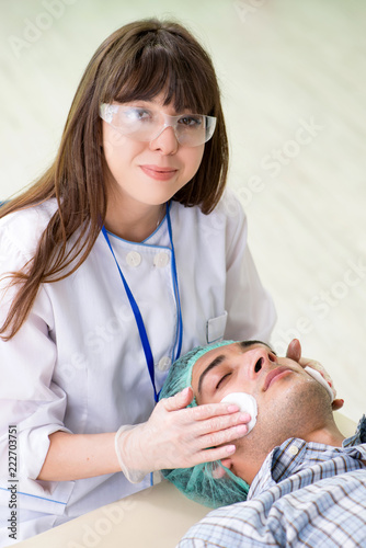 Young man visiting female doctor cosmetologyst 