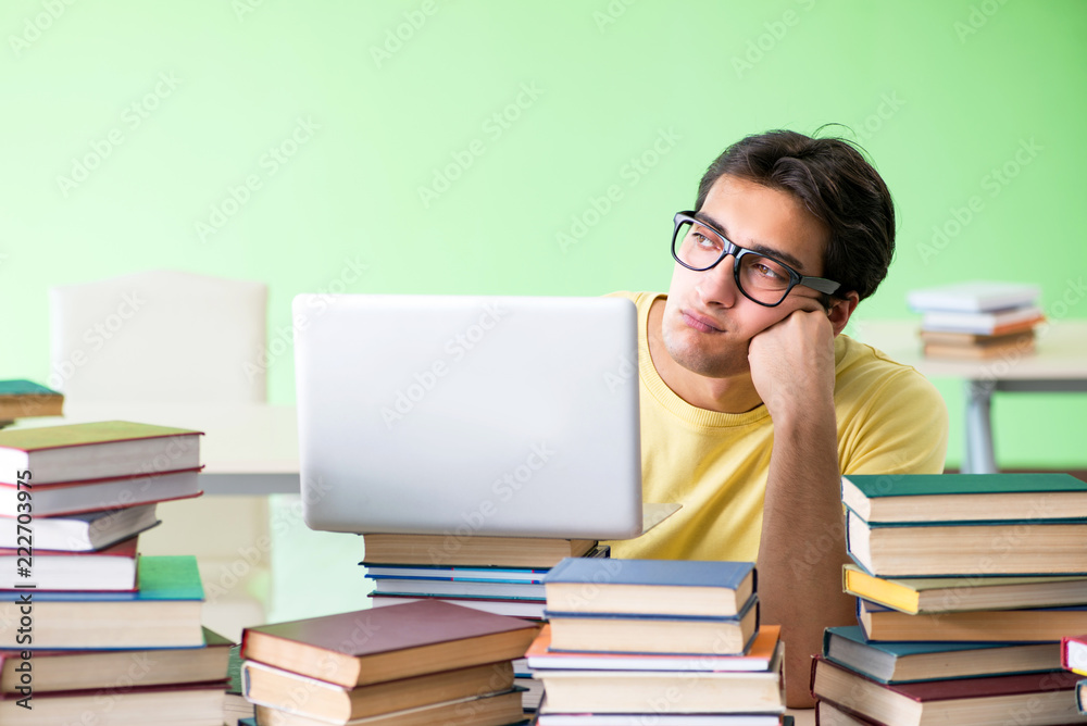 Student with too many books to read before exam Student with too many books to read before exam