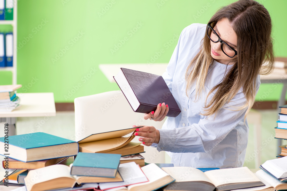Young female student preparing for exams with many books Young female student preparing for exams with many books