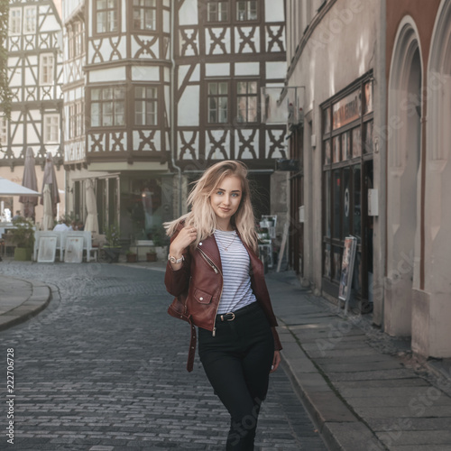 Wallpaper Mural Young beautiful blonde girl is walking along the old European street alone. Torontodigital.ca