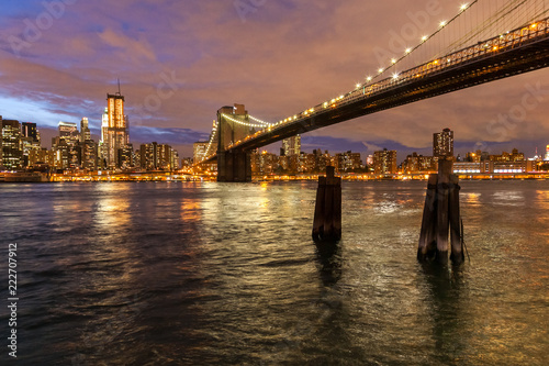 Skyline of New York and Brooklyn bridge at night, New York, USA
