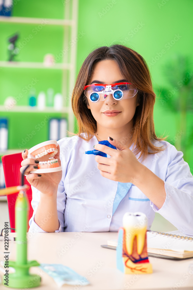 Woman dentist working on teeth implant Woman dentist working on teeth implant